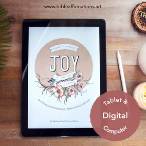 iPad sitting on wooden desk with front cover of Joy Journal loaded. Styled with apple pencil, candles, and fern leaf.